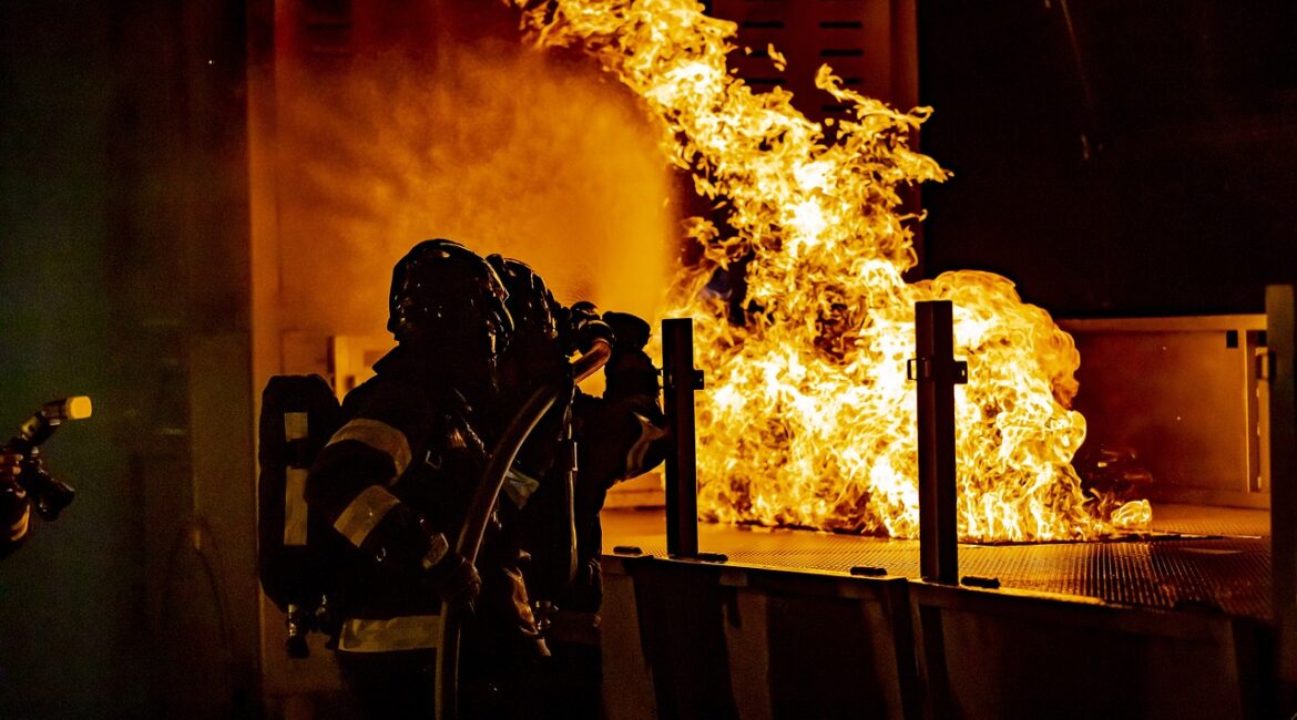 Firefighters preventing industrial fire